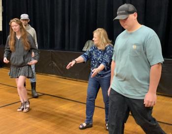 In Stover Auditorium during marching practice May 31, Debra Pooler shows seniors where to be. SUSAN JOHNS/Wiscasset Newspaper 