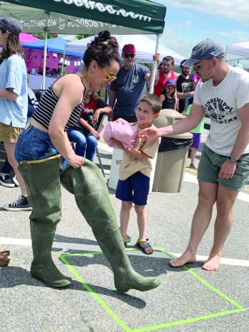 Wiscasset’s Corbin and Lucy Flores-Lichtinger and son Gideon, 7, take part in a relay at Wormfest in Wiscasset June 8. SUSAN JOHNS/Wiscasset Newspaper 