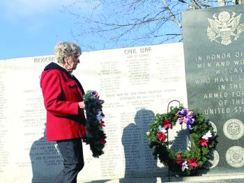 Sandra Winters of American Legion Post 54’s Auxiliary Unit places a wreath at the veterans wall in Wiscasset during Veterans Day ceremonies Nov. 11. SUSAN JOHNS/Wiscasset Newspaper 