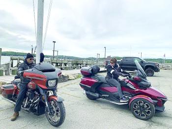 Harpswell’s Ron Gagne, left, on his 2023, “whiskey neat”-colored Harley Davidson, and wife Sue Gagne, on a Canada-made Can Am three-wheel motorcycle, back into parking spots on the Wiscasset waterfront Sept. 7. They planned to meet family and spend time in the area, including the Boothbay Region. SUSAN JOHNS/Wiscasset Newspaper 