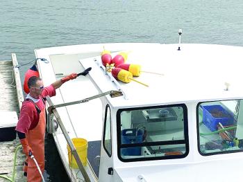A lobsterman cleans the boat on return to the Wiscasset shore Sept. 7. SUSAN JOHNS/Wiscasset Newspaper 