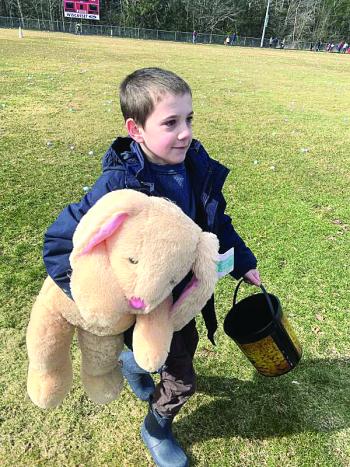 Wiscasset’s Sam Renzi, 8, returns to his family after winning a stuffed bunny at the Easter egg hunt March 30 at the Wiscasset Middle High School track. SUSAN JOHNS/Wiscasset Newspaper 