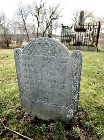 Dated 1739, the headstone of Joshua Pool is the oldest one in the Ancient Cemetery. According to the legend, Pool drowned in the Sheepscot River when an enraged black capsized his canoe. In the background can be seen the Chief Justice Samuel Smith memorial. PHIL DI VECE/Wiscasset Newspaper