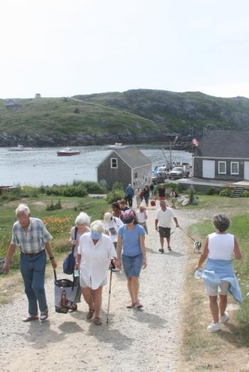 Visitors make their way up the hill on the island. File photo
