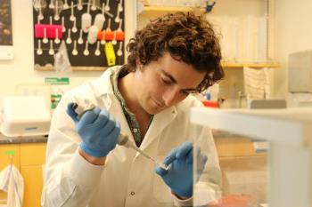 Lead author, Shane Farrell, examines algae samples in the lab. Farrell spent several months on a research visit with co-author Daniel Petras’s at the University of Tübingen in Germany. Courtesy Bigelow Laboratory for Ocean Sciences