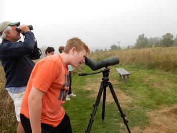 A bird like the fork-tailed flycatcher that comes from such far away lands and that has such a striking appearance interests people of all ages. One of the authors, Jeff Wells, with son catching a look at the fork-tailed flycatcher in Falmouth in 2017. Courtesy of Allison Wells