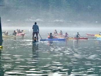 Andy Hollon and his pup Birdie paddleboard together in one of the Y's past Rowgattas. Courtesy of Brooke Hollon 