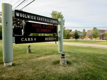 The sign at the entrance of the Woolwich Central School directs motorist to separate lanes for cars and buses. PHIL DI VECE/Wiscasset Newspaper
