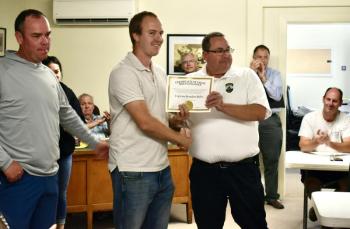 Shown are Woolwich Fire Capt. Brandon Bailey (c) along with Bath Deputy Fire Chief Chris Cummings (r) and Bath Fire Capt. Rick Davis (l). Bailey was recognized for valor and excellence at the scene of a recent fire. PHIL DI VECE/Wiscasset Newspaper