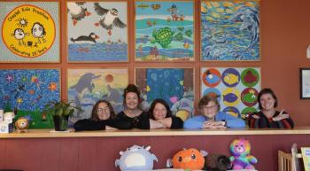 From left: Abi Iverson (Development Director); Senate President Mattie Daughtry, D-Brunswick; Jenn Caron (Executive Director); Priscilla Congdon (Founder); and Sen. Cameron Reny, D-Bristol; in front of murals inspired by children of previous years at Coastal Kids Preschool in Damariscotta. Courtesy photo