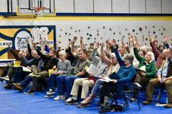 An article to replace funding for Patten Free Library in Bath with a plan to buy library cards for residents who can’t afford one was eventually passed by a show of hands after the town had run out of paper ballots. PHIL DI VECE/Wiscasset Newspaper