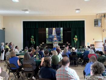 CTL's founder Nancie Atwell speaks to a crowd of alumni and current families in the school's auditorium. Courtesy photo