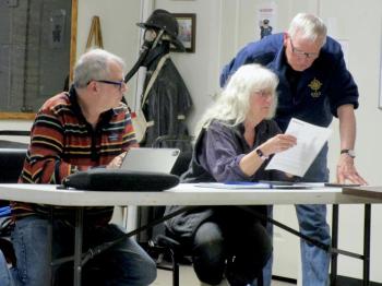 Chairman David King, Sr. looks over the wording of the warrant article with selectman Allison Hepler. Seated at the left is Selectman Tommy Davis. PHIL DI VECE/Wiscasset Newspaper