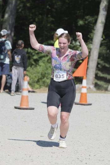 A triathlete celebrates completing the 2025 Pemaquid Beach Triathlon. Photo by Bob Kofman