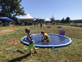 Children enjoying the splash pad at Field & Forest Family Fun Day. This free community event will take place on July 18 at Oak Point Farm. Courtesy of BRLT