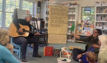 At CTL's Song and Story, Annie Nixon plays guitar while Katy Inman pairs the music with books that engage young learners and their caregivers. Courtesy of CTL