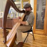 Alex Bigney plays Celtic harp at the Wiscasset Bay Gallery during Wiscasset Art Walk. Lucia Droby photo