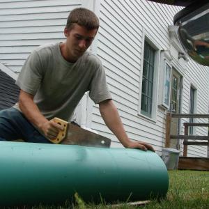 Tyson Day of Wiscasset saws a pipe for a new drainage system on the south side of Edgecomb Town Hall. SUSAN JOHNS/Wiscasset Newspaper Tyson Day of Wiscasset saws a pipe for a new drainage system on the south side of Edgecomb Town Hall. SUSAN JOHNS/Wiscasset Newspaper