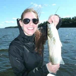 Skye Kinlaw of Maryland happily displays a 17-inch striper she caught and released this past Wednesday. Courtesy of Barry Gibson