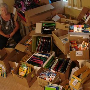 Shown partly surrounded by donated school supplies, Sue Burge is determined to help all students at three area elementary schools start the next school year right. SUSAN JOHNS/Wiscasset Newspaper Shown partly surrounded by donated school supplies, Sue Burge is determined to help all students at three area elementary schools start the next school year right. SUSAN JOHNS/Wiscasset Newspaper