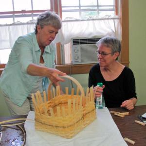 Marè Lemay, demonstrates a basket weaving technique to Mary Hitchcock at Spectrum Generations Coastal Community Center. The next basket-weaving workshop is coming up August 7.