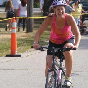 Dianne Gimbel bikes in the Tri for a Cure triathlon in 2011. Below, Gena Canning and her husband Steve register after her first triathlon.