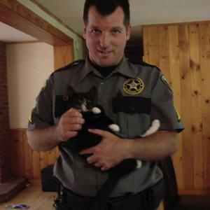 Kyle Canada holds kitten that visited Two Bridges Jail on Aug. 2