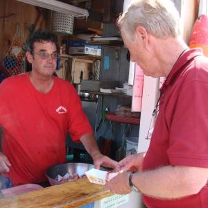 Sprague's Lobster & Clam Bake owner Frank Sprague, left, discusses lobstering and nuclear energy with U.S. Senate candidate and former Maine governor Angus King. SUSAN JOHNS/Wiscasset Newspaper Sprague's Lobster & Clam Bake , Frank Sprague, Maine, Angus King, Wiscasset