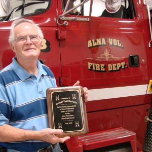 Alna Fire Captain Paul Ouelette holds the plaque the department recently gave him for his service. Ouellette and his wife of 50 years Jackie Ouellette are moving to North Carolina. SUSAN JOHNS/Wiscasset Newspaper Alna Fire Captain Paul Ouelette holds the plaque the department recently gave him for his service. Ouellette and his wife of 50 years Jackie Ouellette are moving to North Carolina. SUSAN JOHNS/Wiscasset Newspaper