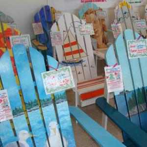 A sampling of 50 colorful Adirondack chairs painted by 50 local artists that are the essence of the YMCA's silent auction. The auction is a fundraiser for the Y's annual fund, this year called the Chair-itable Porch Party. LISA KRISTOFF/Boothbay Register