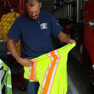 Edgecomb Fire Capt. James Fisk puts away reflective gear back at the town's new fire station, after helping clean up a small oil spill August 17. SUSAN JOHNS/Wiscasset Newspaper