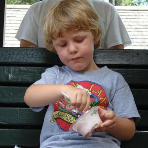 Oscar Gallant enjoys some ice cream while waiting for the train on August 25. Below, a four-legged patron dives into his plain ice cream. SUSAN JOHNS/Wiscasset Newspaper Oscar Gallant enjoys some ice cream while waiting for the train. SUSAN JOHNS/Wiscasset Newspaper