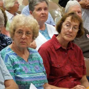 Boothbay Harbor summer resident Connie Machon, left, and her sister, Sharon Barter of Boothbay Harbor, had questions and concerns about the impact of the announced changes. Below, Susan La Placa of Edgecomb awaits the start of the Aug. 22 meeting. SUSAN JOHNS/Wiscasset Newspaper