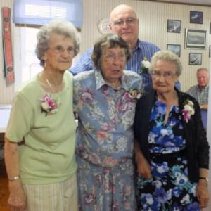 Longtime woolwich grange members receive membership awards. From left, Marion Grover Bailey, Charlotte Waltz Leeman Sutter and Grace Smith receive their awards from Woolwich Grange Master John Hauck, standing in the back. KATHY ONORATO/Wiscasset Newspaper 