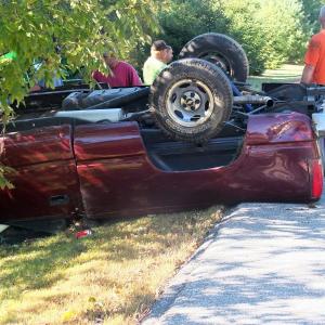 Emergency personnel begin working to get the driver out of the overturned truck. KATHY ONORATO/Wiscasset Newspaper