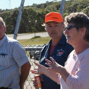 Owner RIchard Jordan, left, and race car driver Dale Chadbourne of Woolwich listen as Vanessa Jordan speaks with drivers and other volunteers about plans for an October race. SUSAN JOHNS/Wiscasset Newspaper