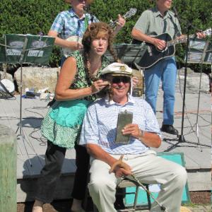 Dick Whittier of Boothbay Harbor volunteers to play a role in a comical song with Debra Arter and the Greenfields at the art fair. Dick Whittier of Boothbay Harbor volunteers to play a role in a comical song with Debra Arter and the Greenfields at the art fair.