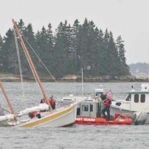 Shipyard workers, Coast Guard personnel and Boothbay Harbor's Harbor Master secured the sailboat which half sunk at its mooring Tuesday afternoon. KEVIN BURNHAM/Boothbay Register