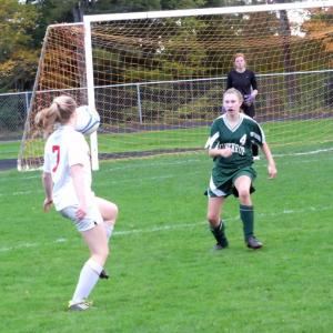 Maeve Carlson traps the ball deep near the Winthrop net