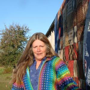 Rhonda Hamlin, pictured the morning after the October 16 earthquake, was in her Wiscasset home working on this Patriots quilt when she felt the quake's vibrations. SUSAN JOHNS/Wiscasset Newspaper