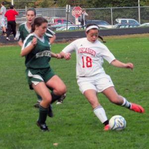 Tylan Onorato moves the ball up field for Wiscasset. Below, Maeve Carlson traps the ball deep near the Winthrop net and Sam Arsenault defends against a Winthrop player. KATHY ONORATO/Wiscasset Newspaper Tylan Onorato moves the ball up field for Wiscasset