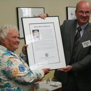 Mary Brewer receives the plaque honoring her as a 2012 inductee into the Maine Press Association's Hall of Fame from Mike Dowd, president of the MPA, at the ceremony held at the Hilton Garden Inn in Freeport October 13. Wiscasset reporter Susan Johns, below, took first place in the News Story category for her article, “Edgecomb board steps out of fireworks store's way,” and third place for her News Story “Alna, Wiscasset residents, officials take stand against dumping.” Wiscasset reporter John Maguire took first place for his Arts & Lifestyle Feature, “My, how I have grown,” a first “tree” story written from the perspective of the giant tree behind Red's Eats. SARAH MORLEY/Boothbay Register Mary Brewer receives the plaque honoring her as a 2012 inductee into the Maine Press Association's Hall of Fame from Mike Dowd, president of the MPA, at the ceremony held at the Hilton Garden Inn in Freeport October 13. SARAH MORLEY/Boothbay Register