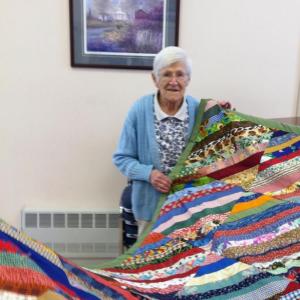 Ruth Applin, a member of the Ladies Organ Society for 80 years, displays a quilt she recently made. At the age of 95, Applin is still very active in the group, and attends their weekly meetings on Wednesdays. CHARLOTTE BOYNTON/Wiscasset Newspaper