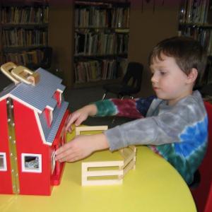 Owen checks out the newly acquired barn and farm animals in the Children’s Room of the Wiscasset Public Library. The barn was a gift from Papa Geppetto’s Workshop on Front Street in Bath. Owen checks out the newly acquired barn and farm animals in the Children’s Room of the Wiscasset Public Library. The barn was a gift from Papa Geppetto’s Workshop on Front Street in Bath.