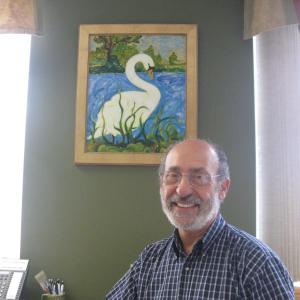 Artist Jim Taliana in front of his painting “Swan” at First Federal Savings. Artist Jim Taliana in front of his painting “Swan” at First Federal Savings.