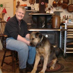 Kilkelly and Estee, who herds the livestock, enjoy a moment by the wood stove. Below: Marge Kilkelly has her goats’ attention as she gets them a hay snack. SUSAN JOHNS/Wiscasset Newspaper Kilkelly and Estee, who herds the livestock, enjoy a moment by the wood stove.