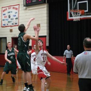 Travis Padilla contests a shot during the boys' game. KATHY ONORATO/Wiscasset Newspaper