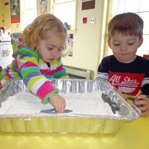 Isabelle Hamilton and Kyle Mank make animal tracks in flour that represented snow, following a reading of Jim Nail’s “Whose Tracks Are These?” at Wiscasset Public Library. Below: Grace Segerstrom and J. J. Pray enjoy the train and tracks set donated to the Wiscasset Public Library Children’s Room by Papa Geppetto’s Workshop. Courtesy of Wiscasset Public Library Isabelle Hamilton and Kyle Mank make animal tracks in flour that represented snow, following a reading of Jim Nail’s “Whose Tracks Are These?” at Wiscasset Public Library. Courtesy of Wiscasset Public Library