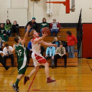 Matt Craig takes the ball to the basket. Below: Dale Peaslee makes his way inside for a layup, and Austin Haskell launches a shot up over a Carrabec defender. Courtesy of John Anzalone Matt Craig takes the ball to the basket.