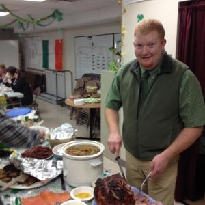Lincoln County EMA/Communications Assistant Director Casey Stevens carves the ham. jOHN MAGUIRE/Wiscasset Newspaper
